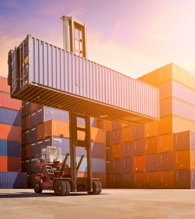 Logistic cargo container in shipping yard with cargo container stack in background. Photo concept for Global business shipping,Logistic,Import and Export industries.